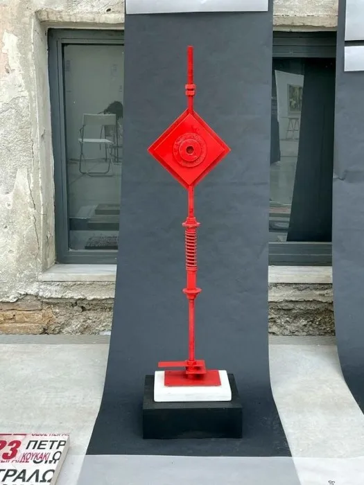 Άποψη από την εγκατάσταση «Διαδρομές»: χάρτινοι διάδρομοι σε μαύρο και γκρι στρωμένοι στο δάπεδο βιομηχανικού χώρου, με τα έργα των καλλιτεχνών και τυπωμένους στίχους τοποθετημένους πάνω τους.